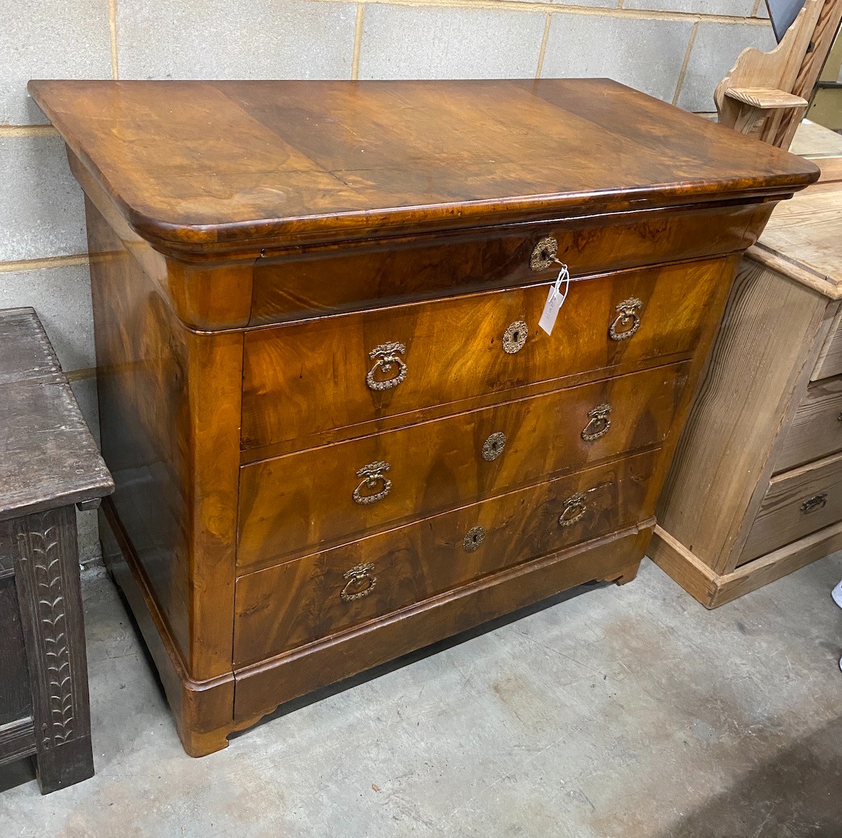 A French Second Empire figured walnut commode, fitted with four long guilt metal mounted drawers, 123 cm wide, 103 cm high, 62 cm deep